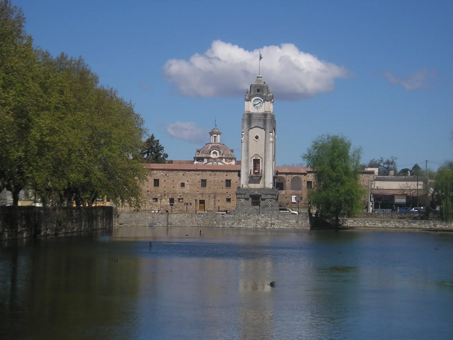 Historic buildings seen across Alta Gracia Tajamar reservoir