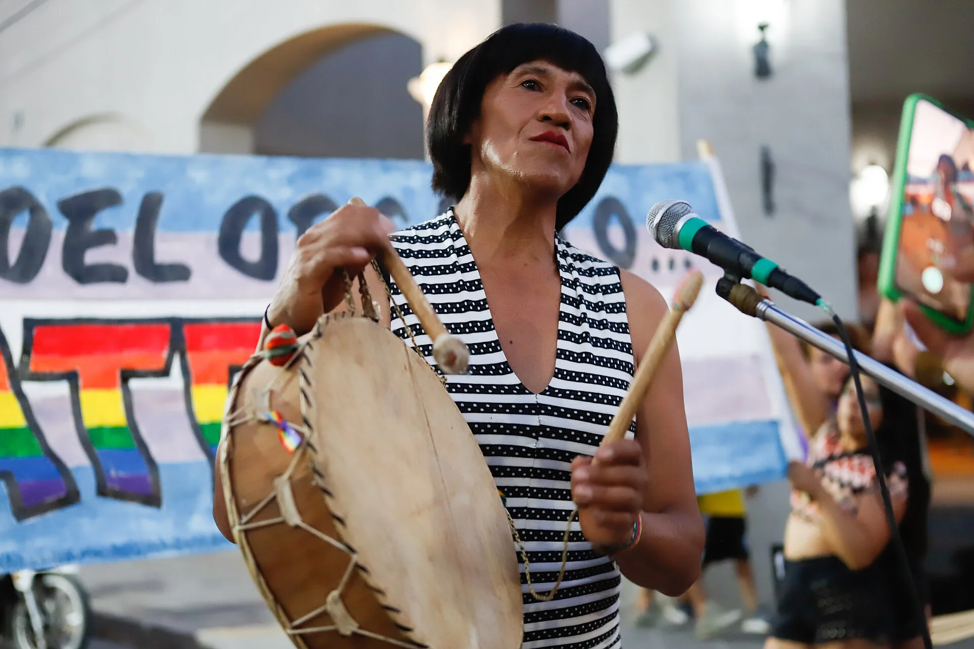 Lorena Carpanchay singing and playing a drum at the 2023 Cafayate Pride event