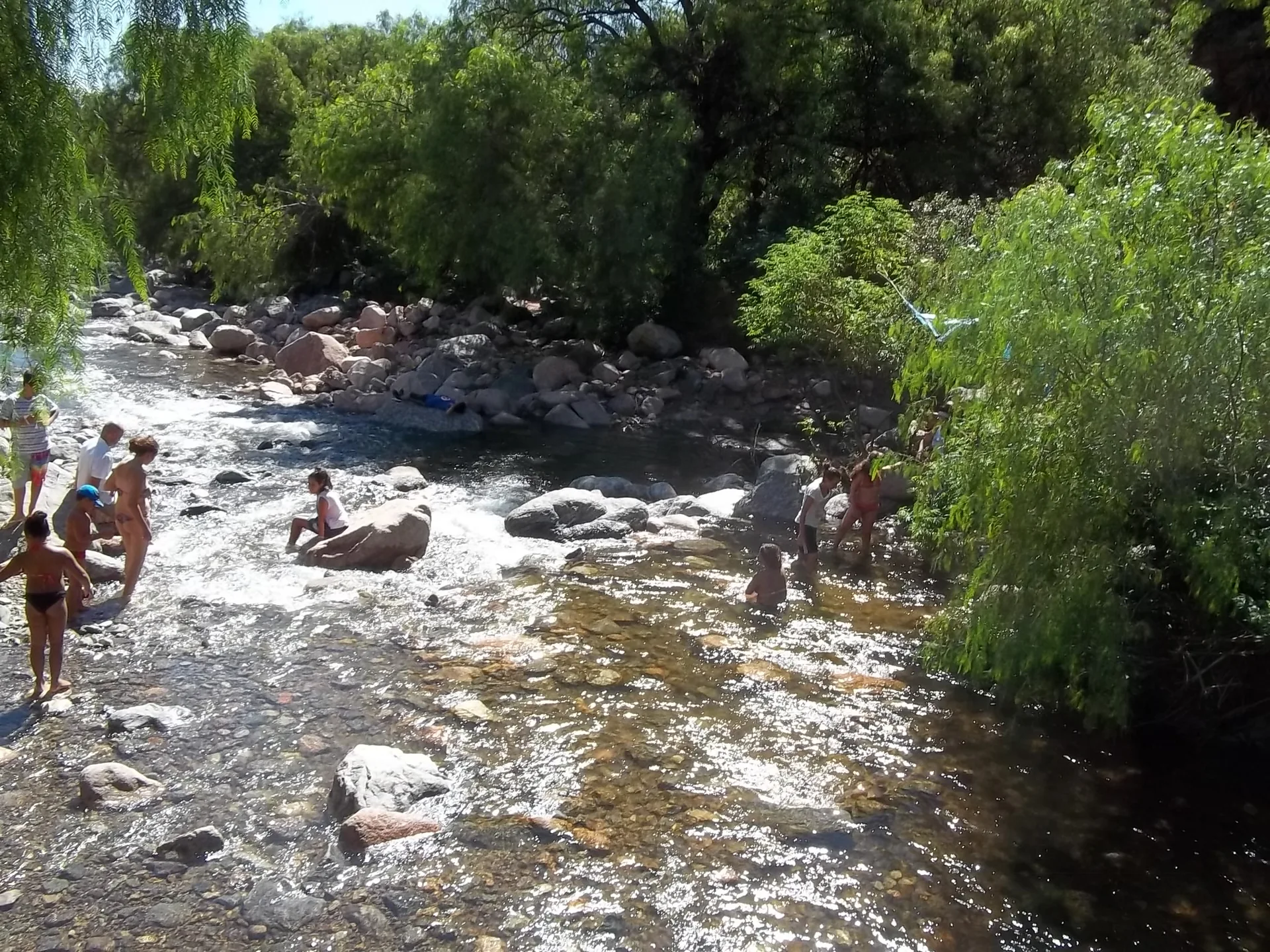 Rocky Calabalumba river channel with trees in Capilla del Monte