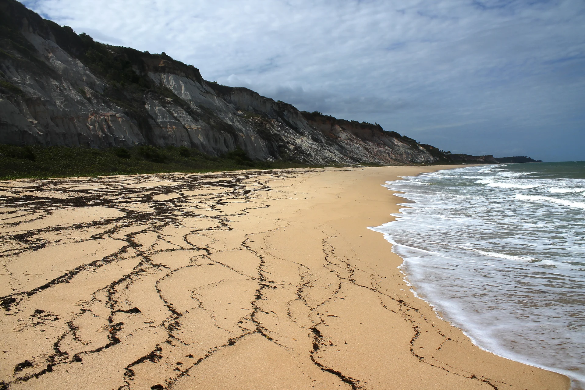 Sandy Arraial d'Ajuda beach beside pale cliffs and the Atlantic shore