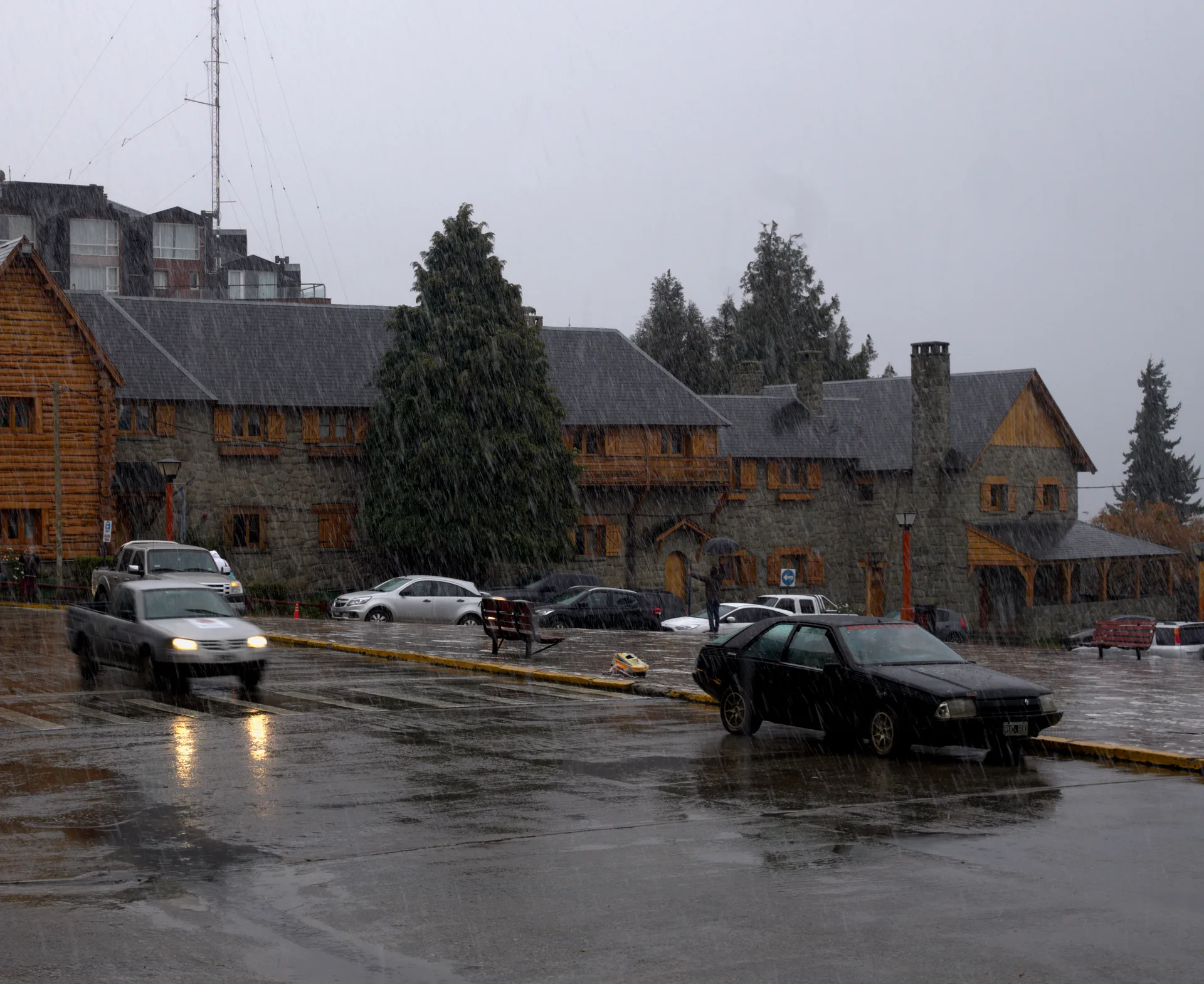 Snow falling over Centro Cívico and wet roads in Bariloche