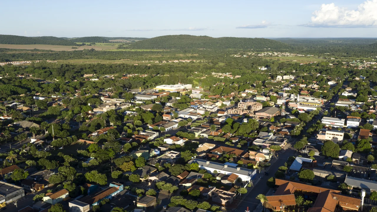 Aerial view over Bonito buildings, trees and the surrounding low hills