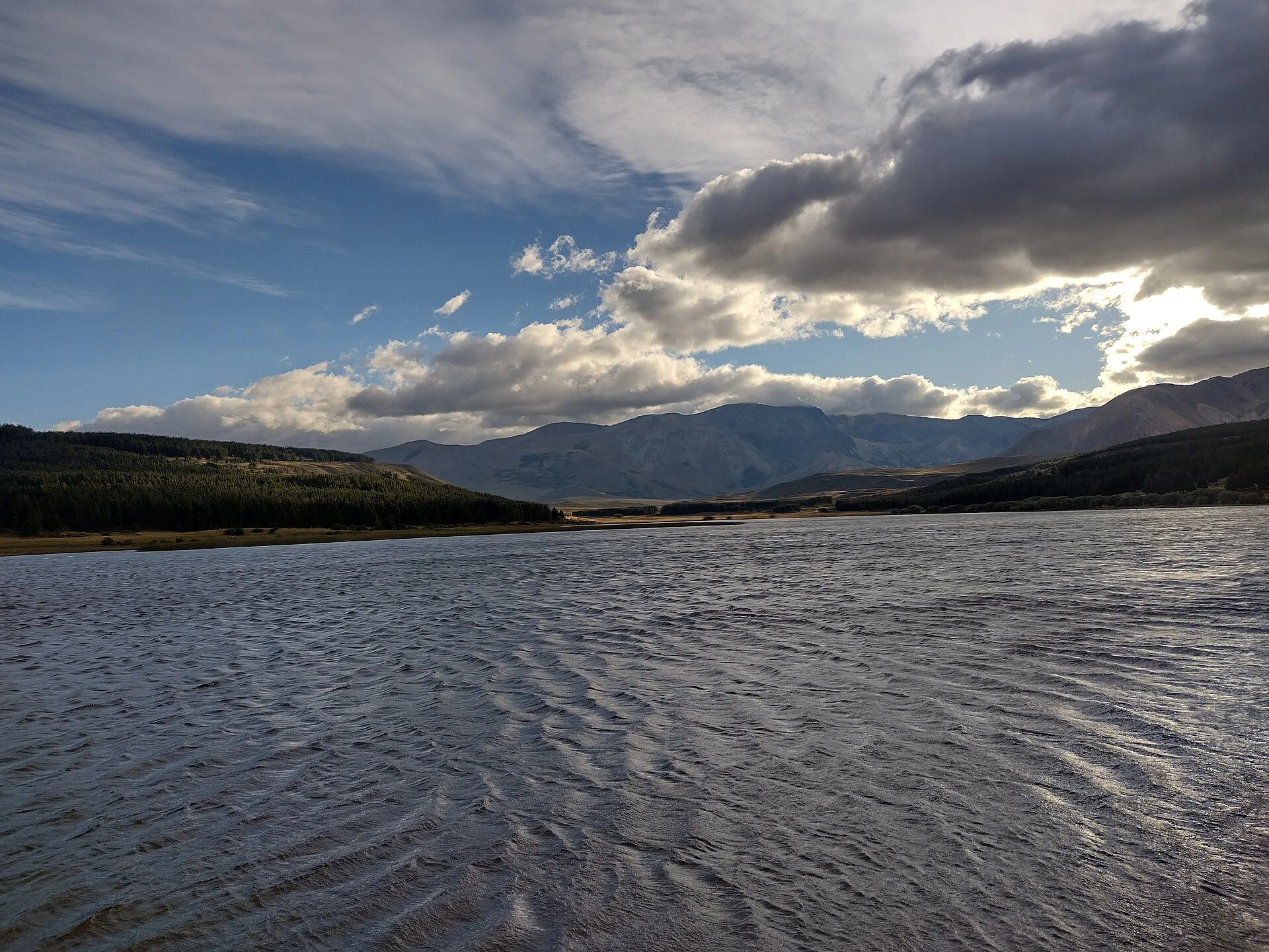 Laguna La Zeta with a wooded shore and mountains near Esquel
