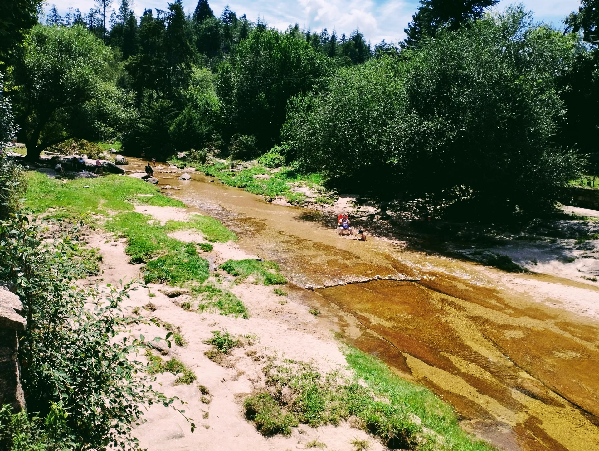 A stream among trees and rocks in La Cumbrecita