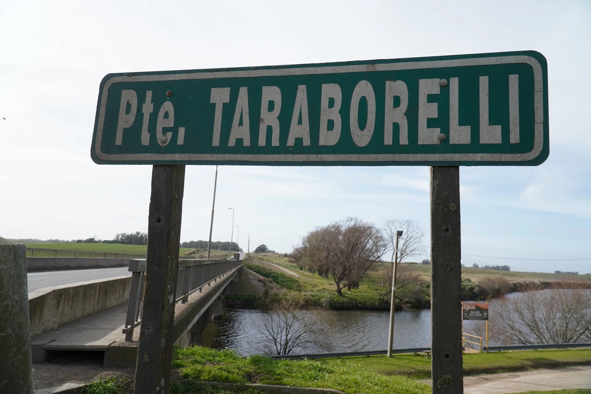 Taraborelli Bridge sign, road and river in a historical photograph
