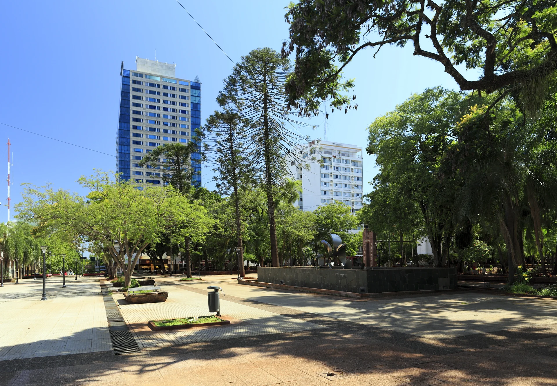 Plaza 9 de Julio in central Posadas, with gardens, trees and nearby buildings