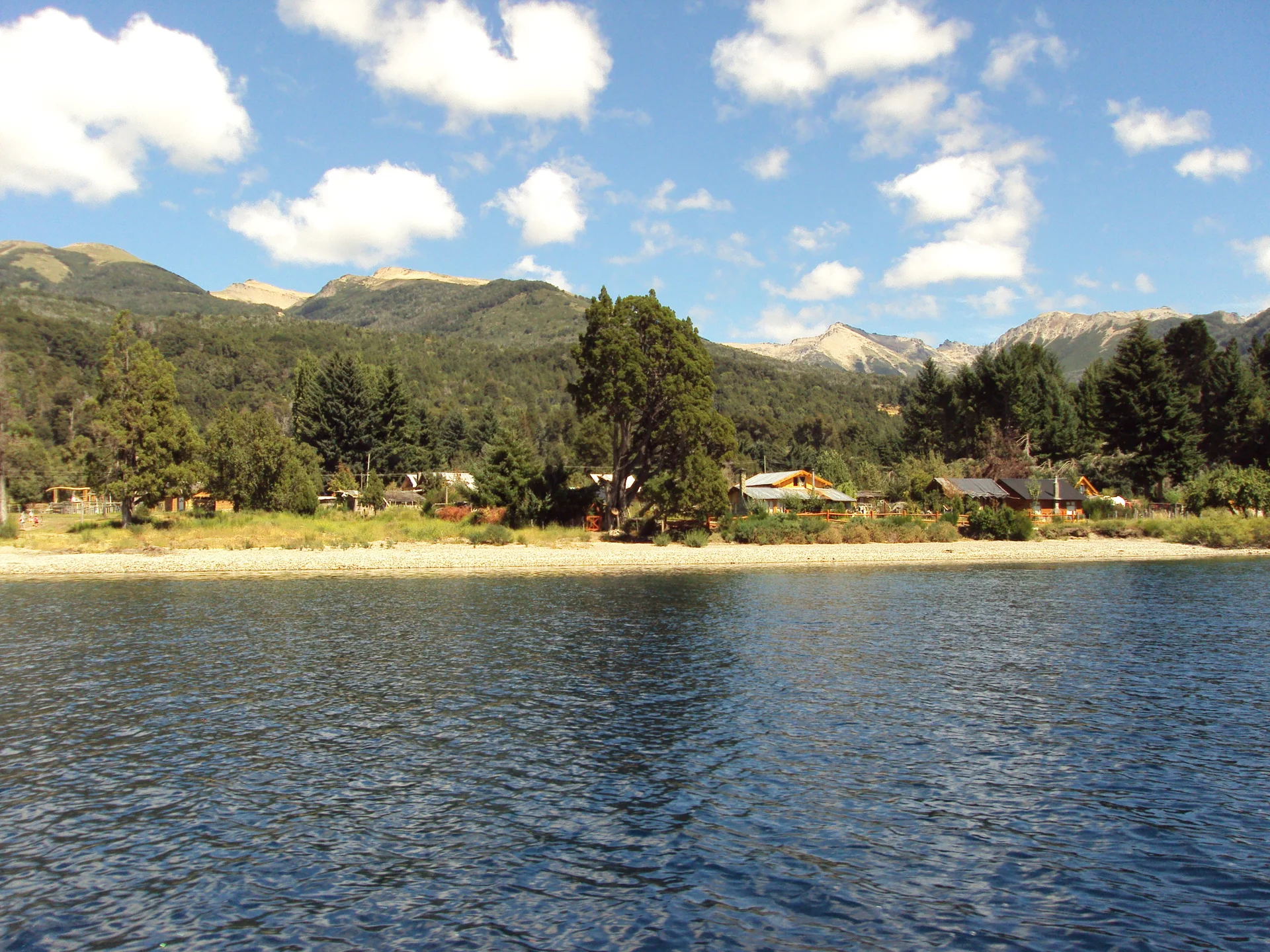Villa Traful shoreline, buildings and forested hills viewed from the lake, photographed March 7, 2011